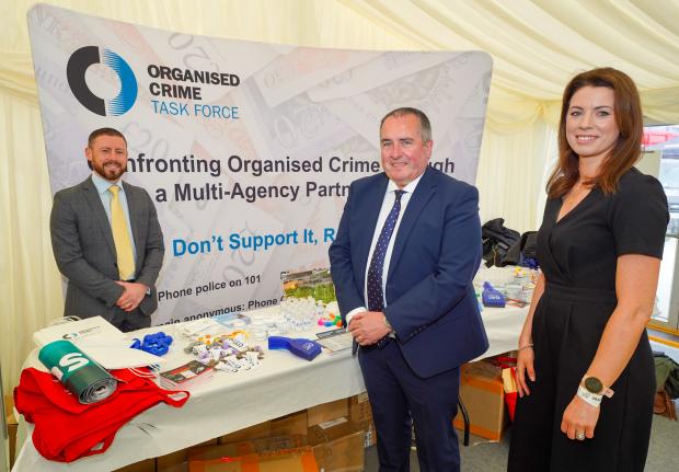 OCTF stand at the Balmoral Show 2022, pictured are a number of OCTF partners - D/C/ Inspector Barry Hamilton (PSNI), Mark Goodfellow (Director, Safer Communities, DOJ) and Amanda Logan (NIEA). 