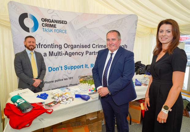 OCTF stand at the Balmoral Show 2022, pictured are a number of OCTF partners - D/C/ Inspector Barry Hamilton (PSNI), Mark Goodfellow (Director, Safer Communities, DOJ) and Amanda Logan (NIEA).